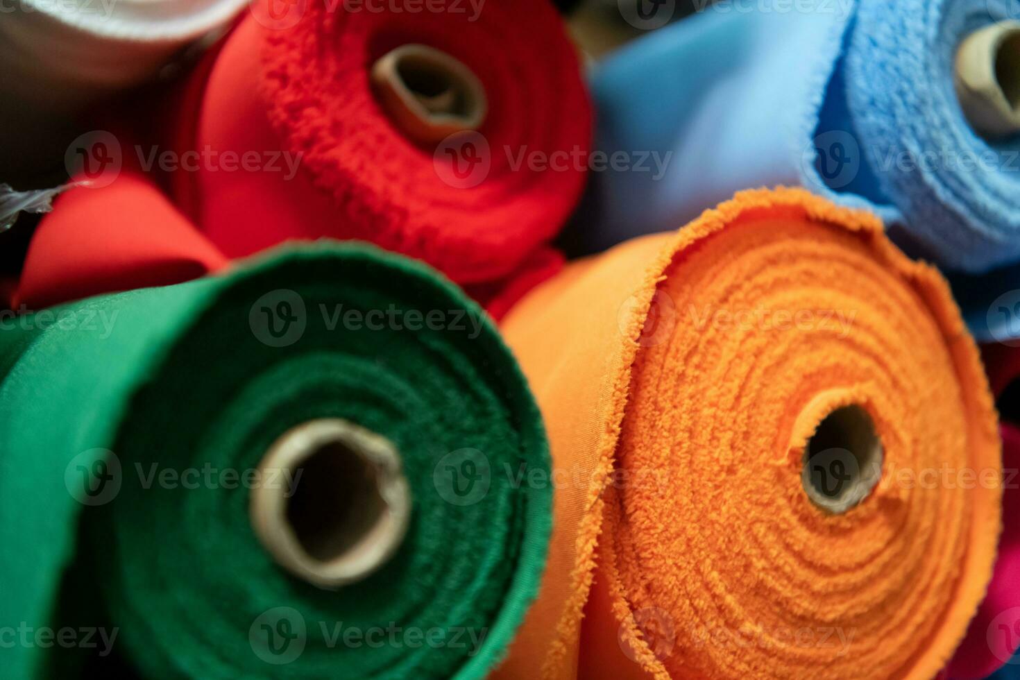 Collection of fashionable fabrics. Samples of different natural fabrics for sewing a fashion collection of clothes. Large selection of fabrics in the store or tailor warehouse. photo