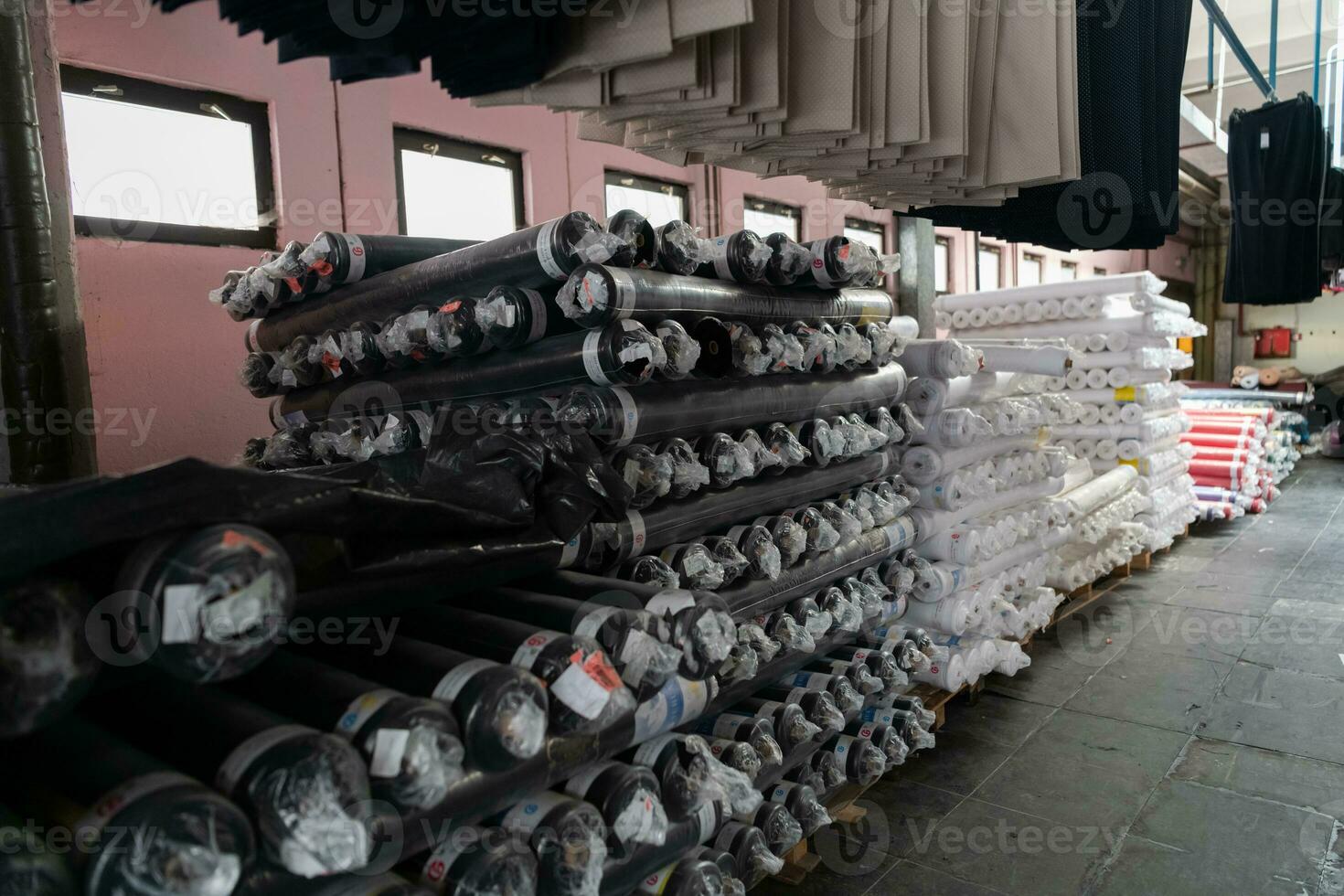 Interior of an industrial warehouse with fabric rolls samples. Small business textile colorful warehouse. photo