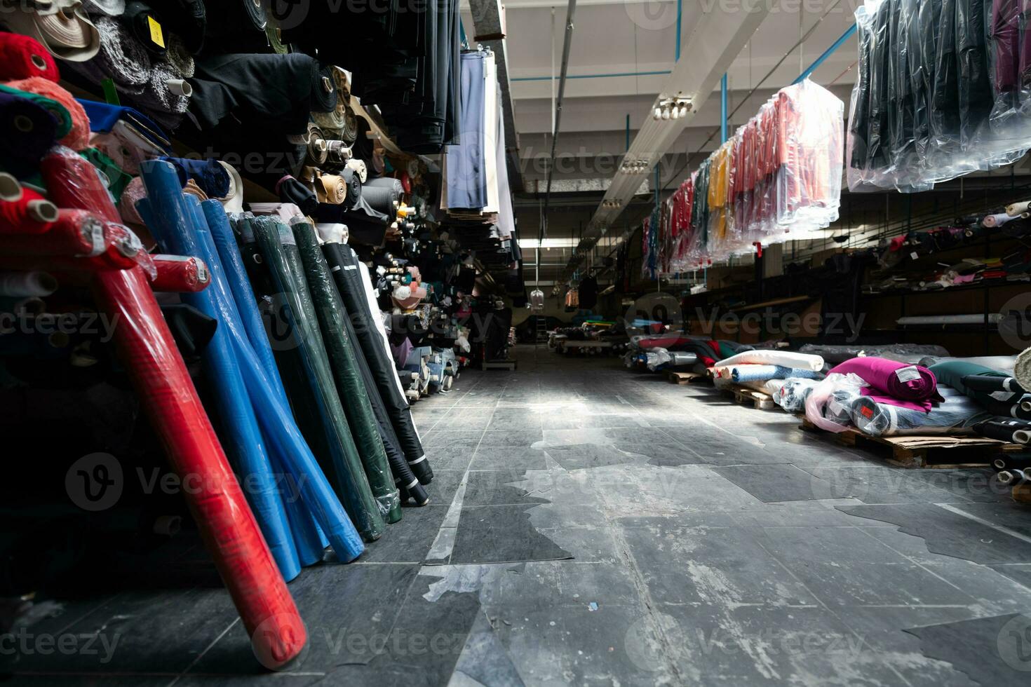 Interior of an industrial warehouse with fabric rolls samples. Small business textile colorful warehouse. photo