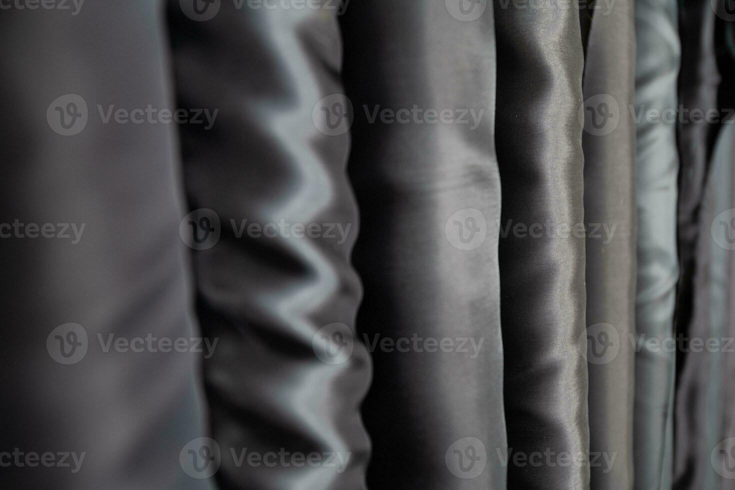 Collection of fashionable fabrics. Samples of different natural fabrics for sewing a fashion collection of clothes. Large selection of fabrics in the store or tailor warehouse. photo
