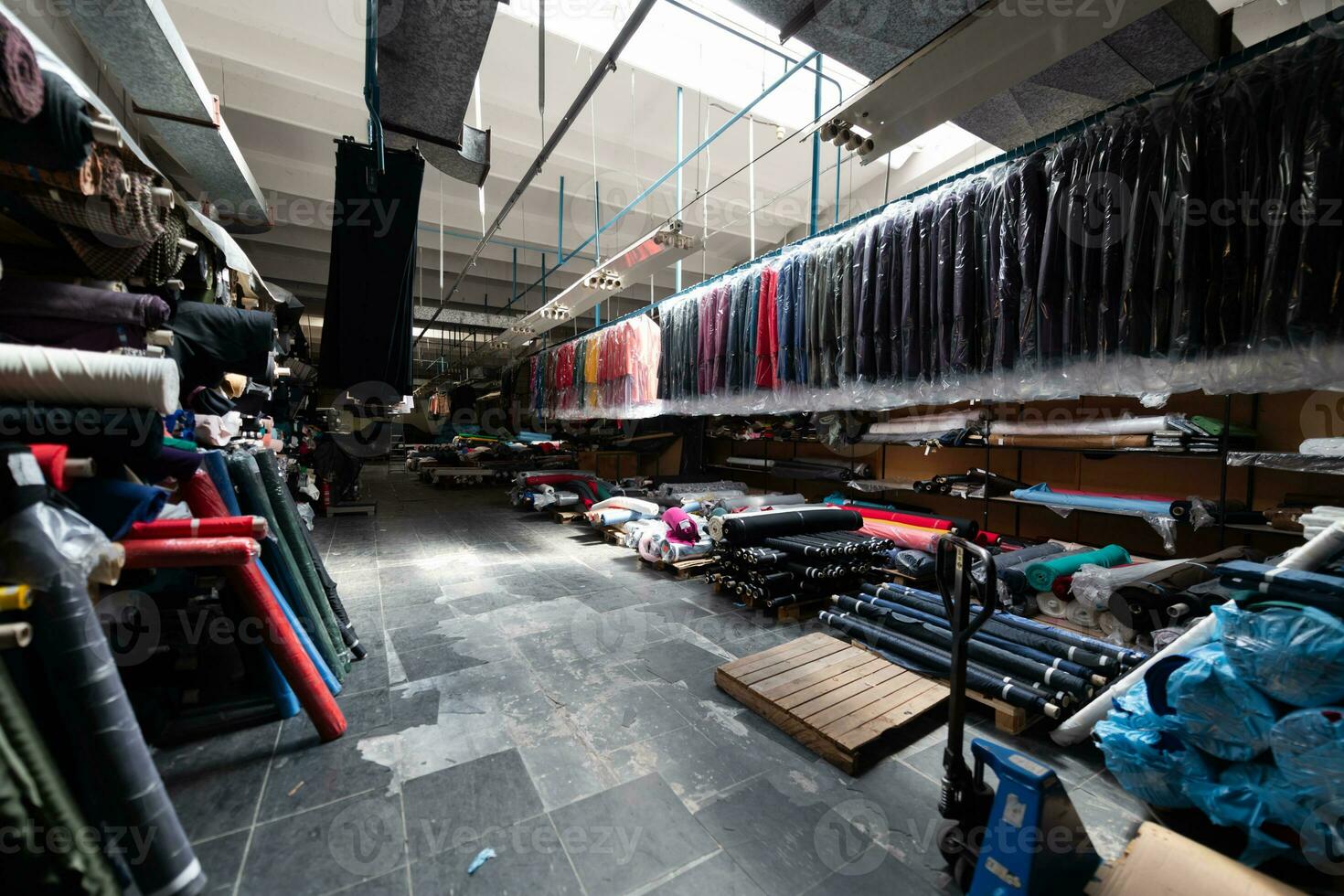 Interior of an industrial warehouse with fabric rolls samples. Small business textile colorful warehouse. photo