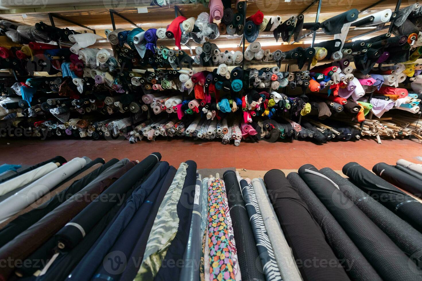 Interior of an industrial warehouse with fabric rolls samples. Small business textile colorful warehouse. photo