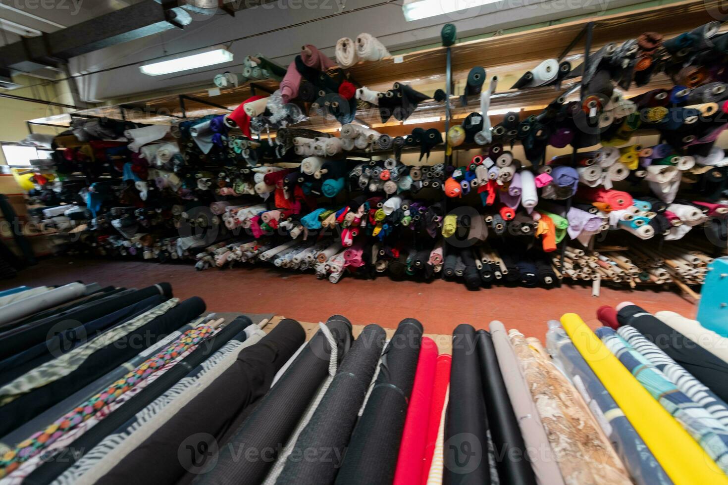 Interior of an industrial warehouse with fabric rolls samples. Small business textile colorful warehouse. photo