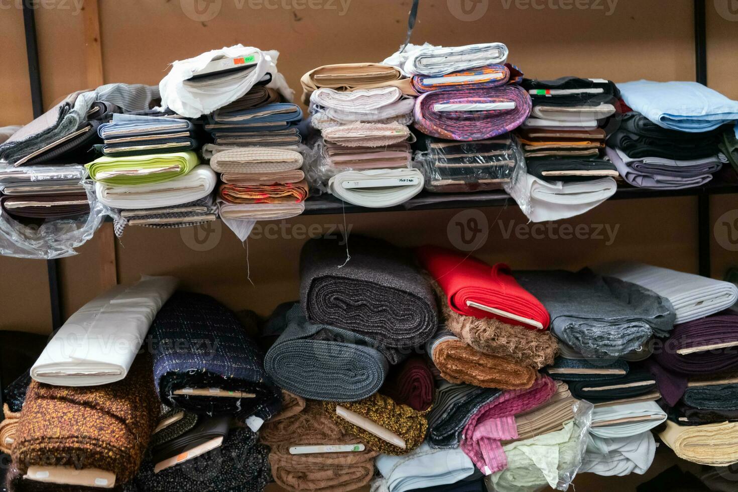 Interior of an industrial warehouse with fabric rolls samples. Small business textile colorful warehouse. photo