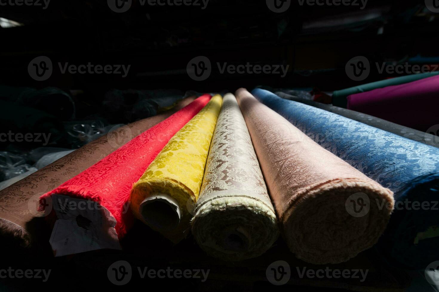 Collection of fashionable fabrics. Samples of different natural fabrics for sewing a fashion collection of clothes. Large selection of fabrics in the store or tailor warehouse. photo