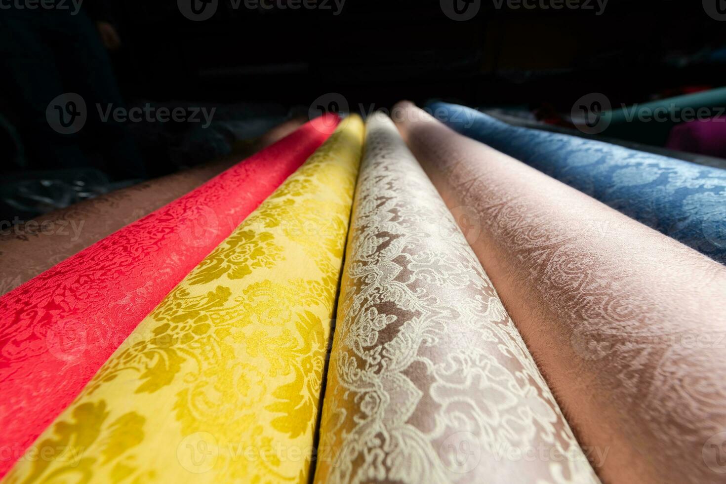 Collection of fashionable fabrics. Samples of different natural fabrics for sewing a fashion collection of clothes. Large selection of fabrics in the store or tailor warehouse. photo