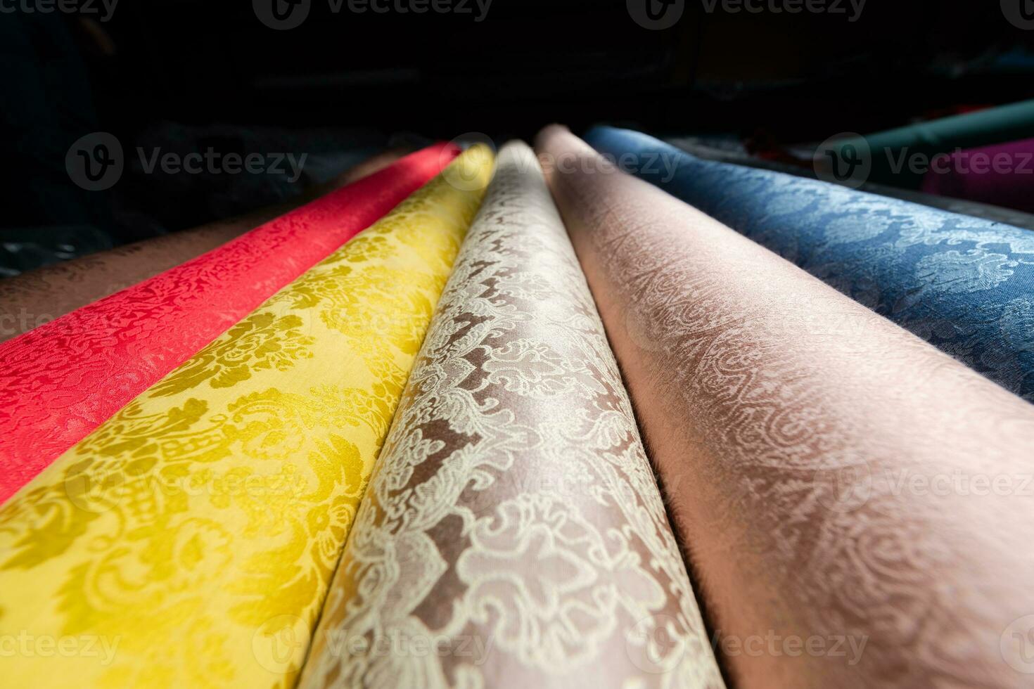 Collection of fashionable fabrics. Samples of different natural fabrics for sewing a fashion collection of clothes. Large selection of fabrics in the store or tailor warehouse. photo
