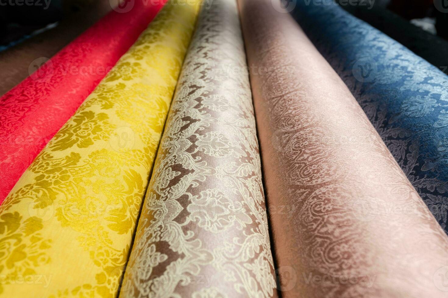 Collection of fashionable fabrics. Samples of different natural fabrics for sewing a fashion collection of clothes. Large selection of fabrics in the store or tailor warehouse. photo