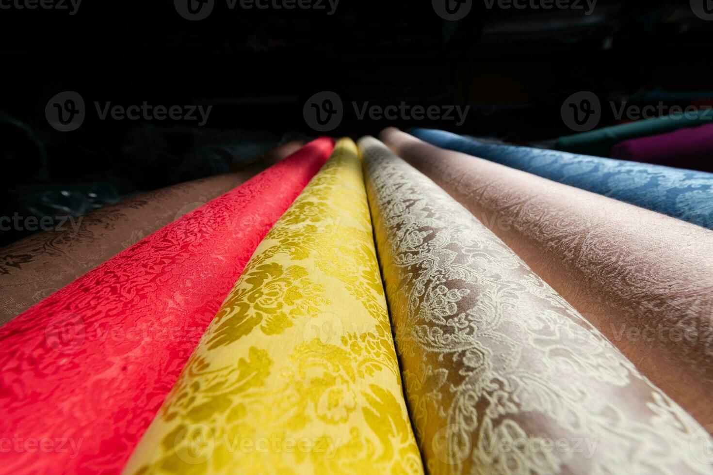 Collection of fashionable fabrics. Samples of different natural fabrics for sewing a fashion collection of clothes. Large selection of fabrics in the store or tailor warehouse. photo