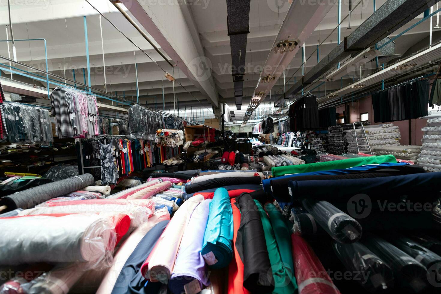 Interior of an industrial warehouse with fabric rolls samples. Small business textile colorful warehouse. photo