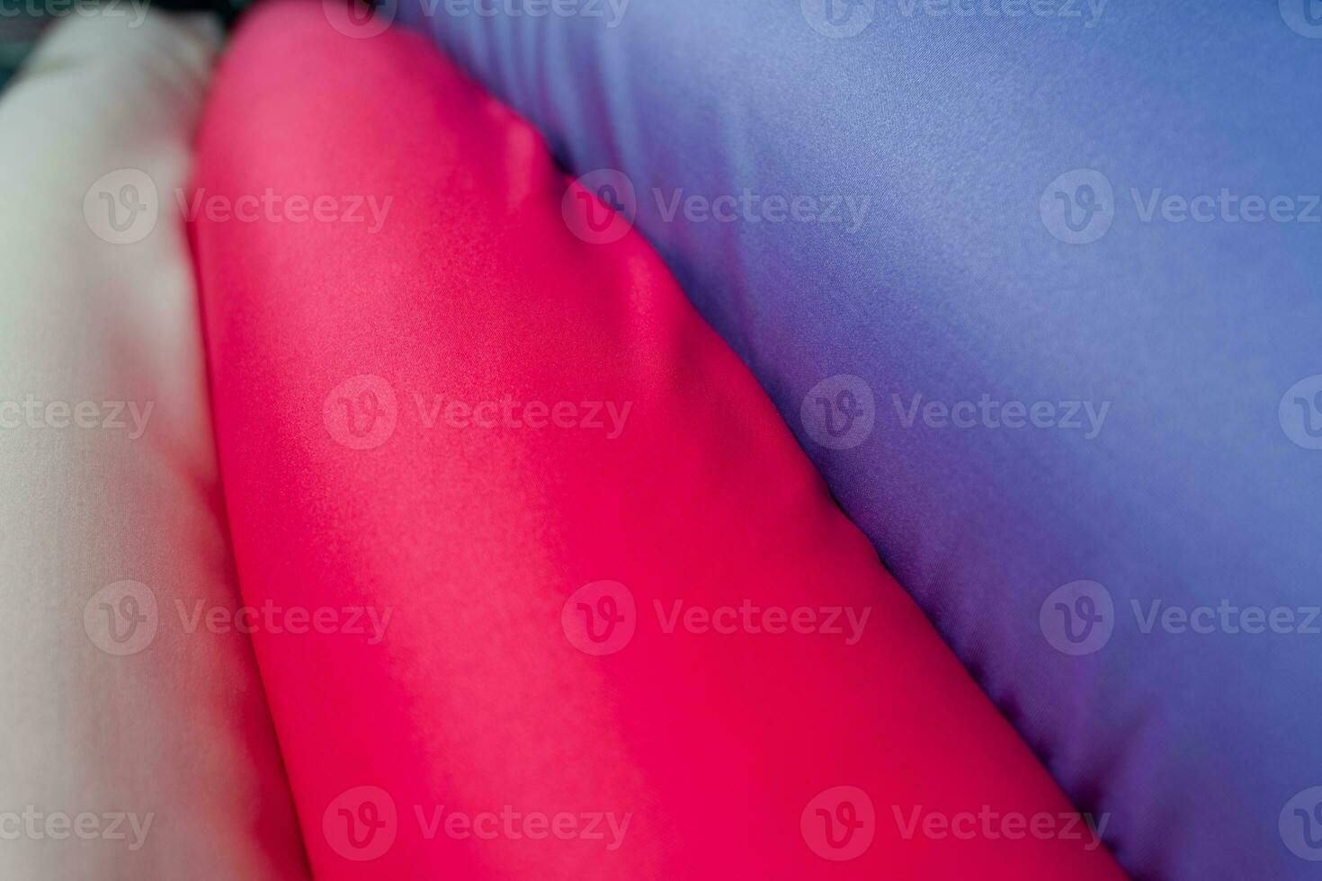 Collection of fashionable fabrics. Samples of different natural fabrics for sewing a fashion collection of clothes. Large selection of fabrics in the store or tailor warehouse. photo