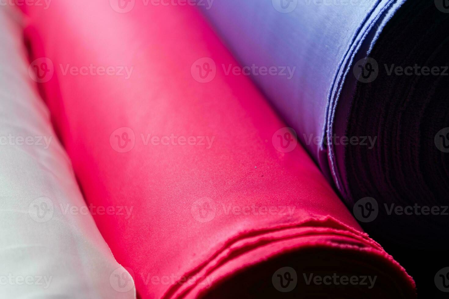 Collection of fashionable fabrics. Samples of different natural fabrics for sewing a fashion collection of clothes. Large selection of fabrics in the store or tailor warehouse. photo