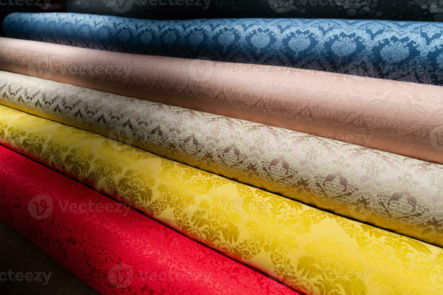 Collection of fashionable fabrics. Samples of different natural fabrics for sewing a fashion collection of clothes. Large selection of fabrics in the store or tailor warehouse. photo