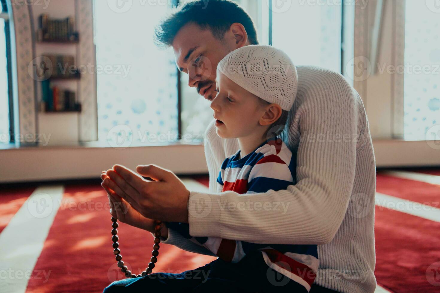 Muslim prayer father and son in mosque prayingtogether photo