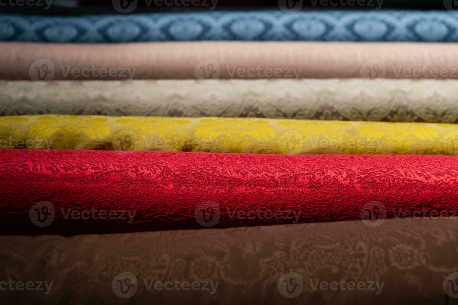 Collection of fashionable fabrics. Samples of different natural fabrics for sewing a fashion collection of clothes. Large selection of fabrics in the store or tailor warehouse. photo