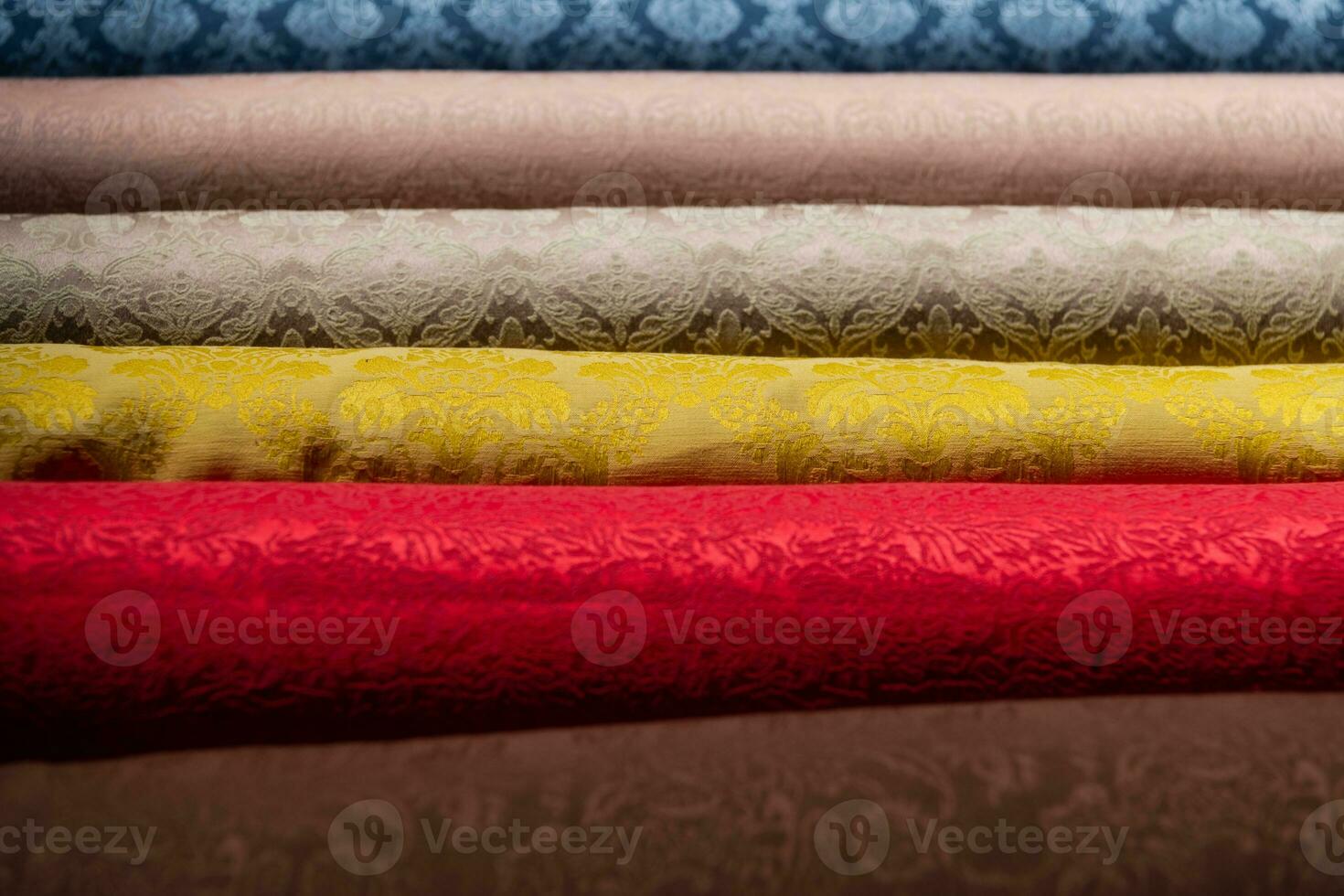 Collection of fashionable fabrics. Samples of different natural fabrics for sewing a fashion collection of clothes. Large selection of fabrics in the store or tailor warehouse. photo
