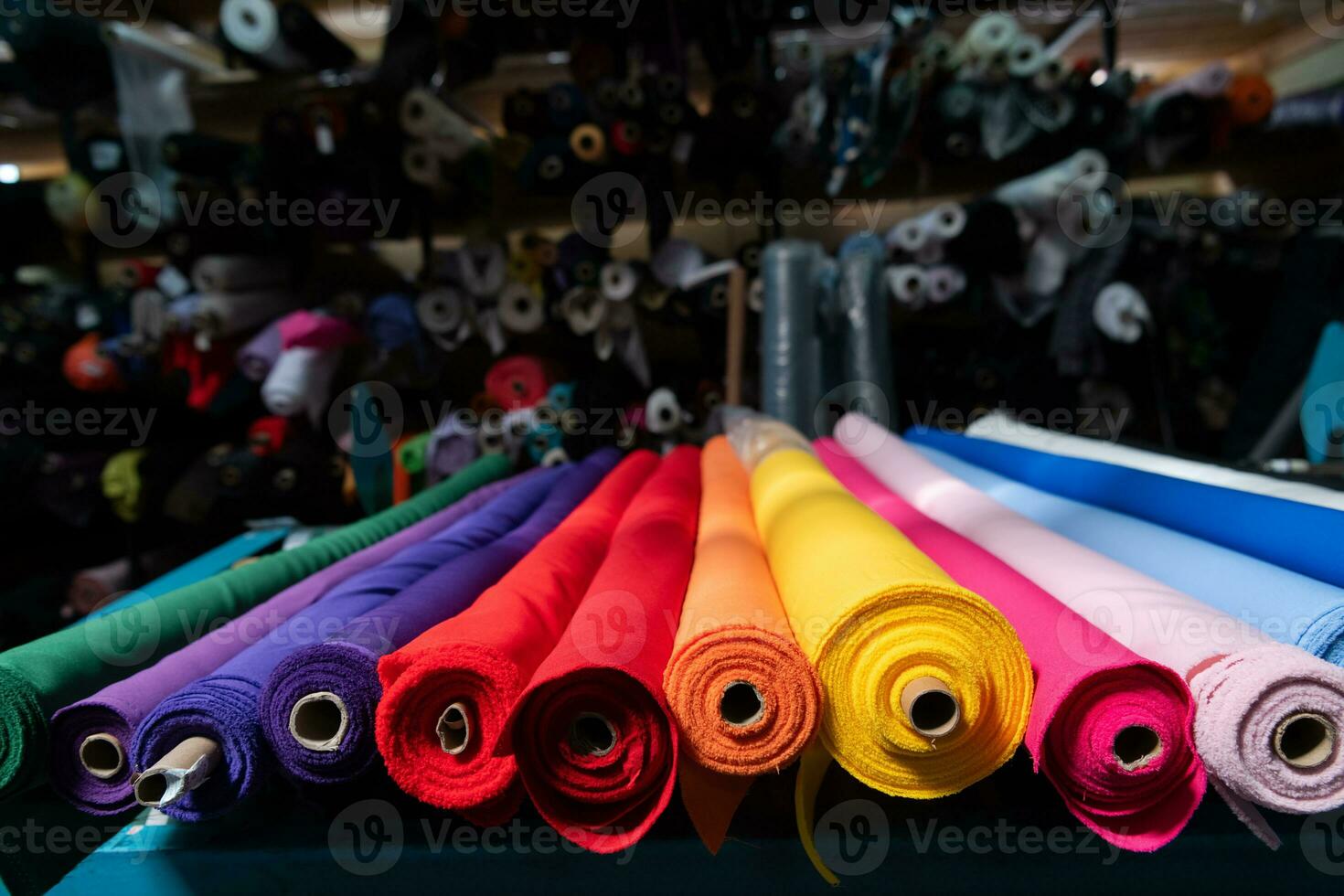 Interior of an industrial warehouse with fabric rolls samples. Small business textile colorful warehouse. photo