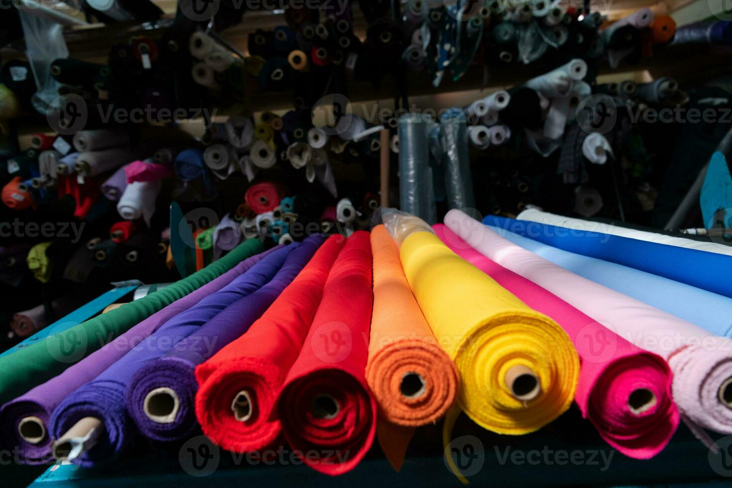 Interior of an industrial warehouse with fabric rolls samples. Small business textile colorful warehouse. photo