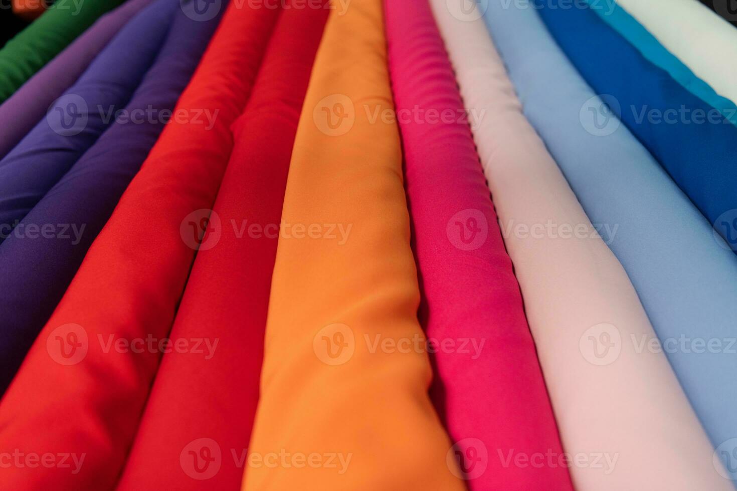 Collection of fashionable fabrics. Samples of different natural fabrics for sewing a fashion collection of clothes. Large selection of fabrics in the store or tailor warehouse. photo