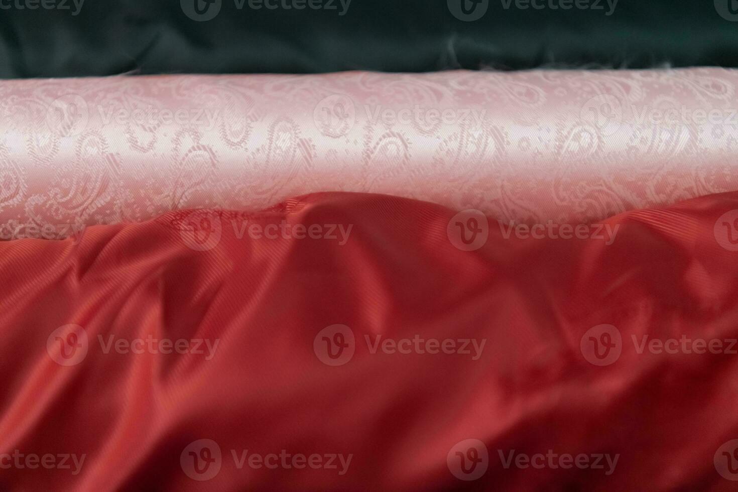 Collection of fashionable fabrics. Samples of different natural fabrics for sewing a fashion collection of clothes. Large selection of fabrics in the store or tailor warehouse. photo