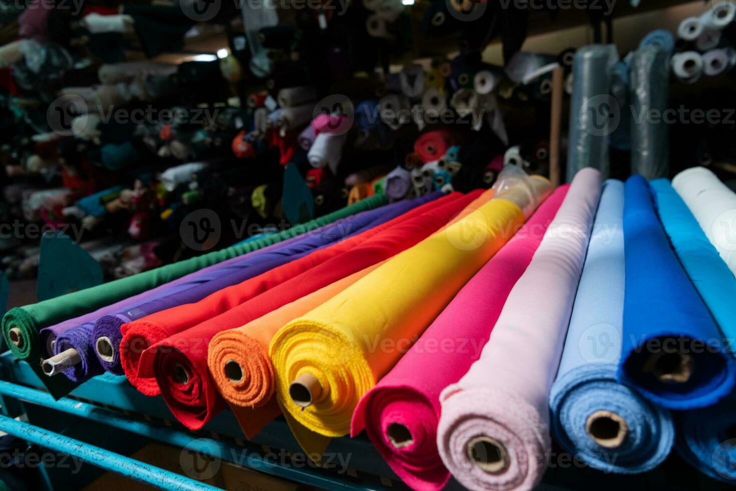 Interior of an industrial warehouse with fabric rolls samples. Small business textile colorful warehouse. photo