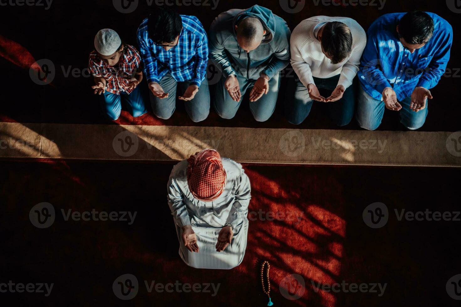 A group of Muslims in a modern mosque praying the Muslim prayer namaz, during the holy month of Ramadan photo