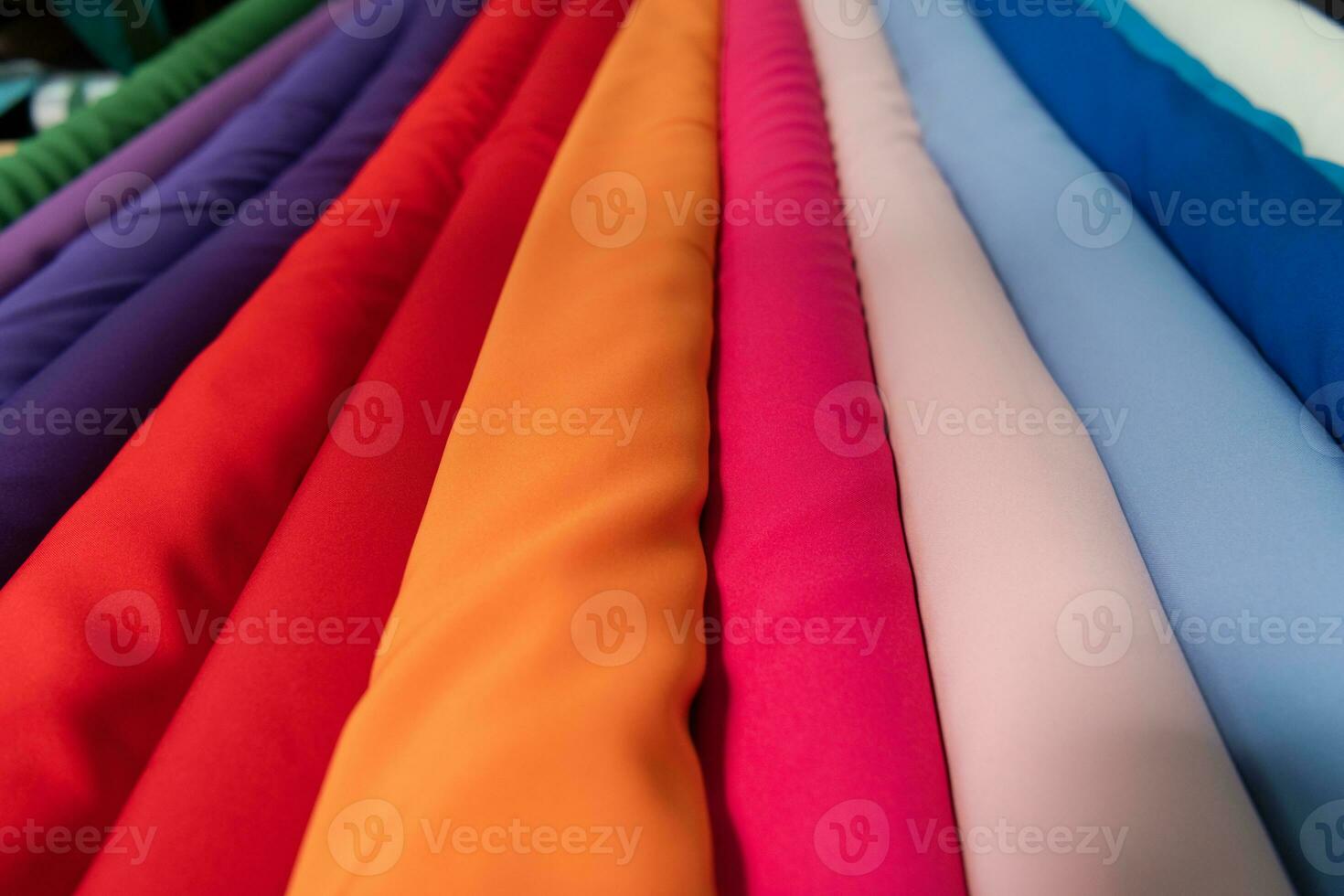 Collection of fashionable fabrics. Samples of different natural fabrics for sewing a fashion collection of clothes. Large selection of fabrics in the store or tailor warehouse. photo
