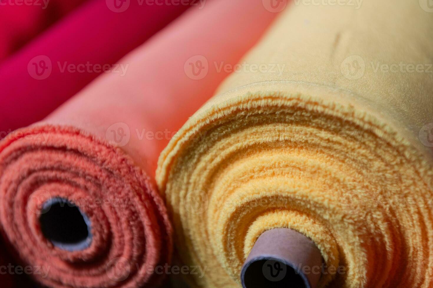 Collection of fashionable fabrics. Samples of different natural fabrics for sewing a fashion collection of clothes. Large selection of fabrics in the store or tailor warehouse. photo