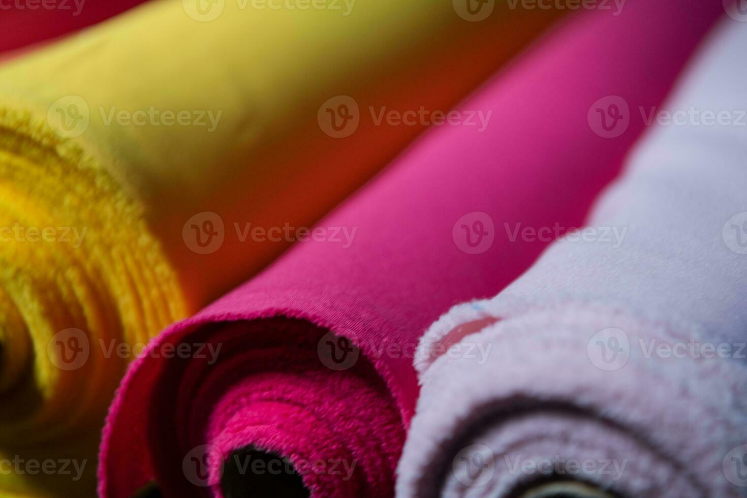 Collection of fashionable fabrics. Samples of different natural fabrics for sewing a fashion collection of clothes. Large selection of fabrics in the store or tailor warehouse. photo