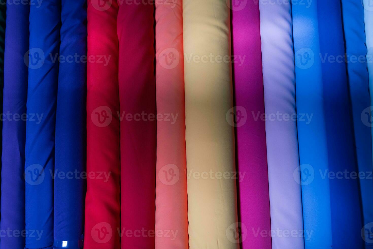 Collection of fashionable fabrics. Samples of different natural fabrics for sewing a fashion collection of clothes. Large selection of fabrics in the store or tailor warehouse. photo