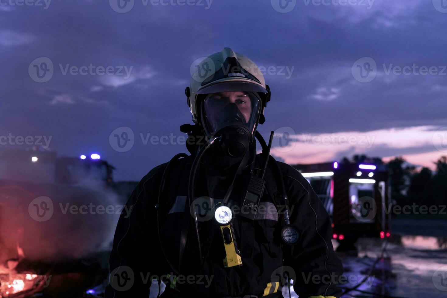 Portrait of a heroic fireman in a protective suit. Firefighter in fire fighting operation. photo