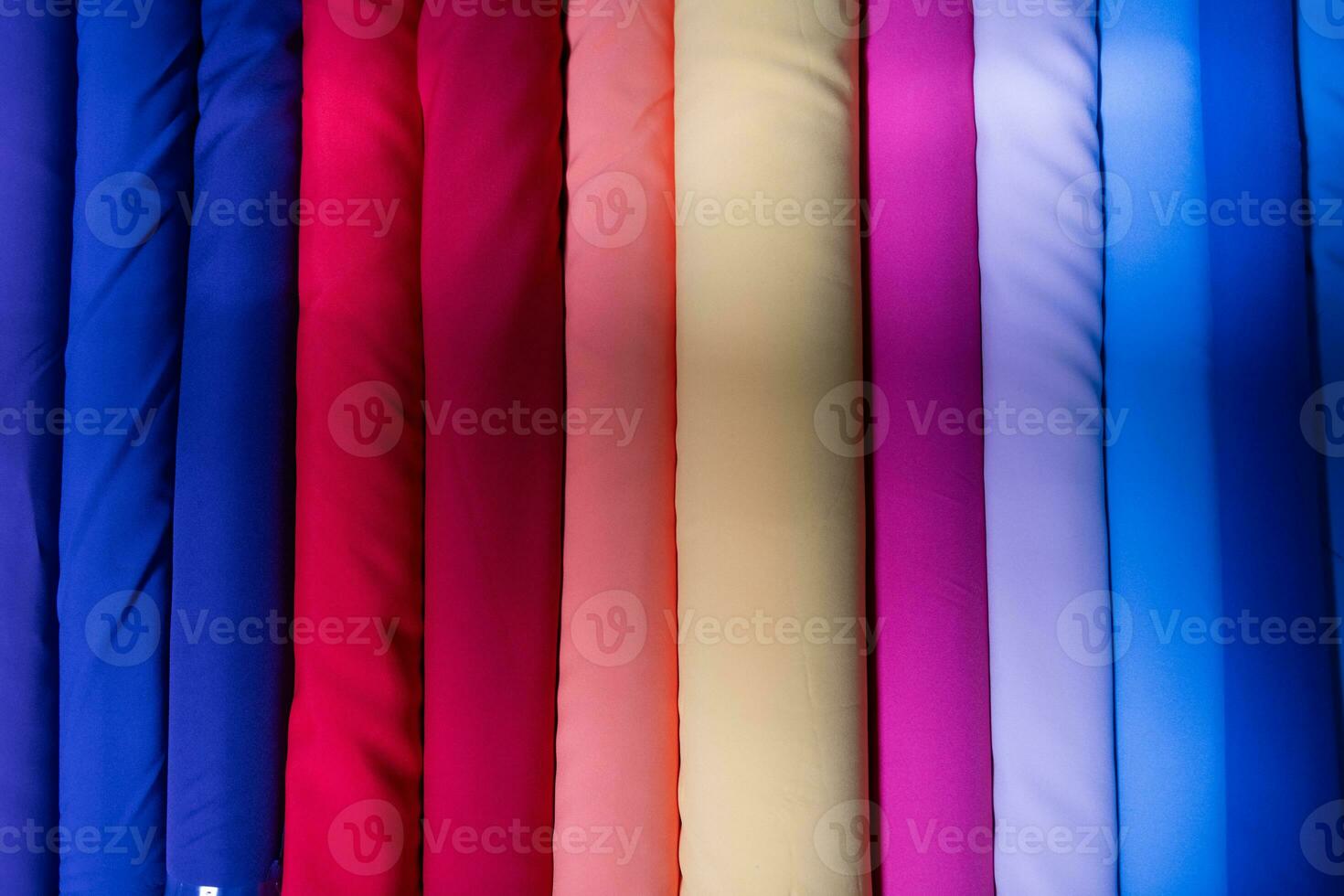 Collection of fashionable fabrics. Samples of different natural fabrics for sewing a fashion collection of clothes. Large selection of fabrics in the store or tailor warehouse. photo