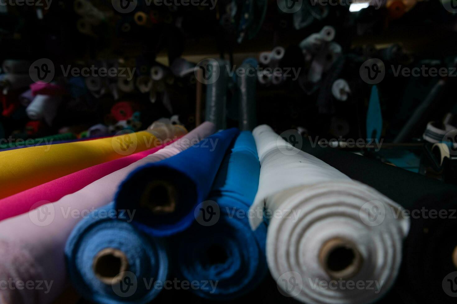 Interior of an industrial warehouse with fabric rolls samples. Small business textile colorful warehouse. photo