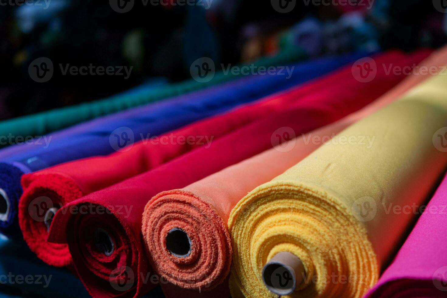 Collection of fashionable fabrics. Samples of different natural fabrics for sewing a fashion collection of clothes. Large selection of fabrics in the store or tailor warehouse. photo