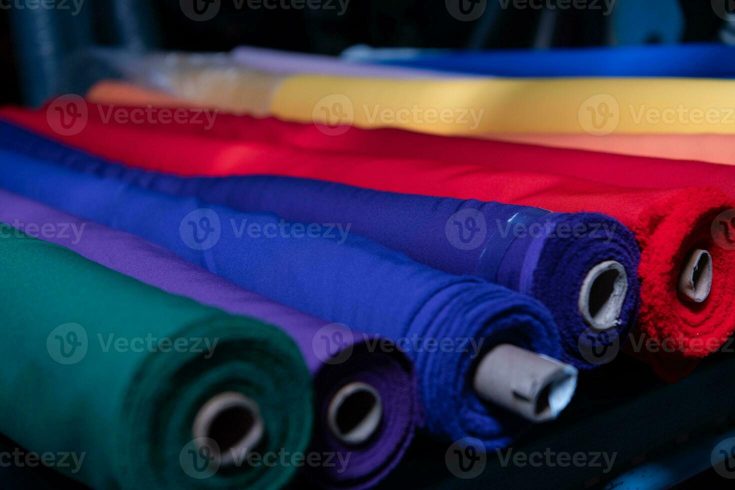 Collection of fashionable fabrics. Samples of different natural fabrics for sewing a fashion collection of clothes. Large selection of fabrics in the store or tailor warehouse. photo