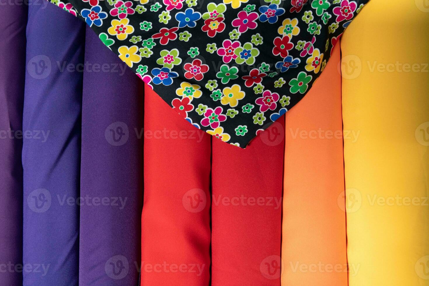 Collection of fashionable fabrics. Samples of different natural fabrics for sewing a fashion collection of clothes. Large selection of fabrics in the store or tailor warehouse. photo