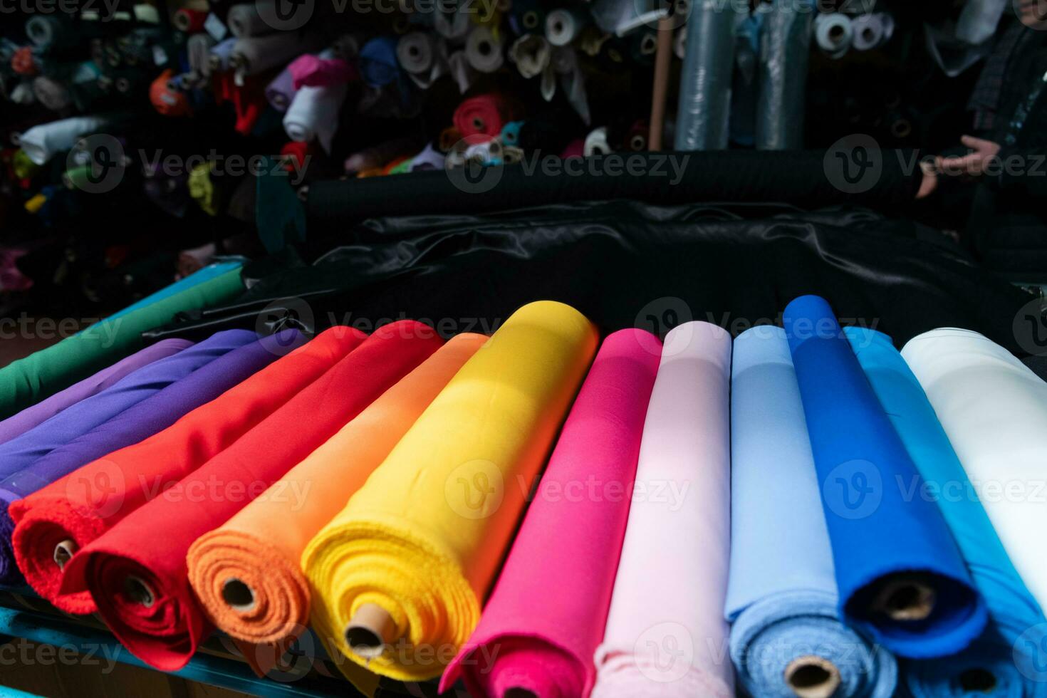 Interior of an industrial warehouse with fabric rolls samples. Small business textile colorful warehouse. photo