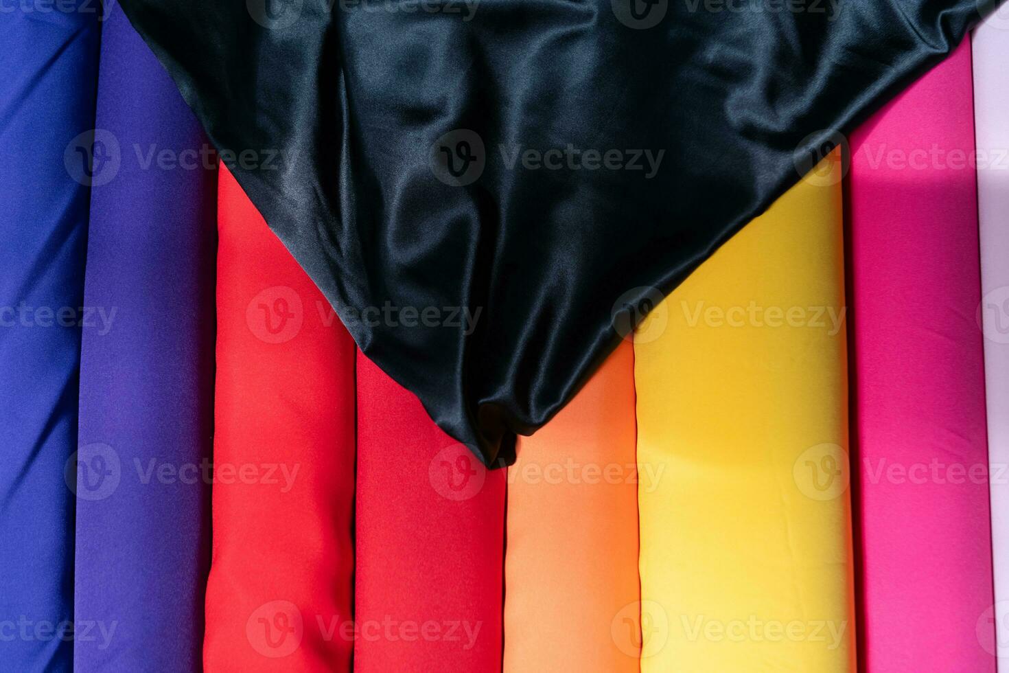Collection of fashionable fabrics. Samples of different natural fabrics for sewing a fashion collection of clothes. Large selection of fabrics in the store or tailor warehouse. photo