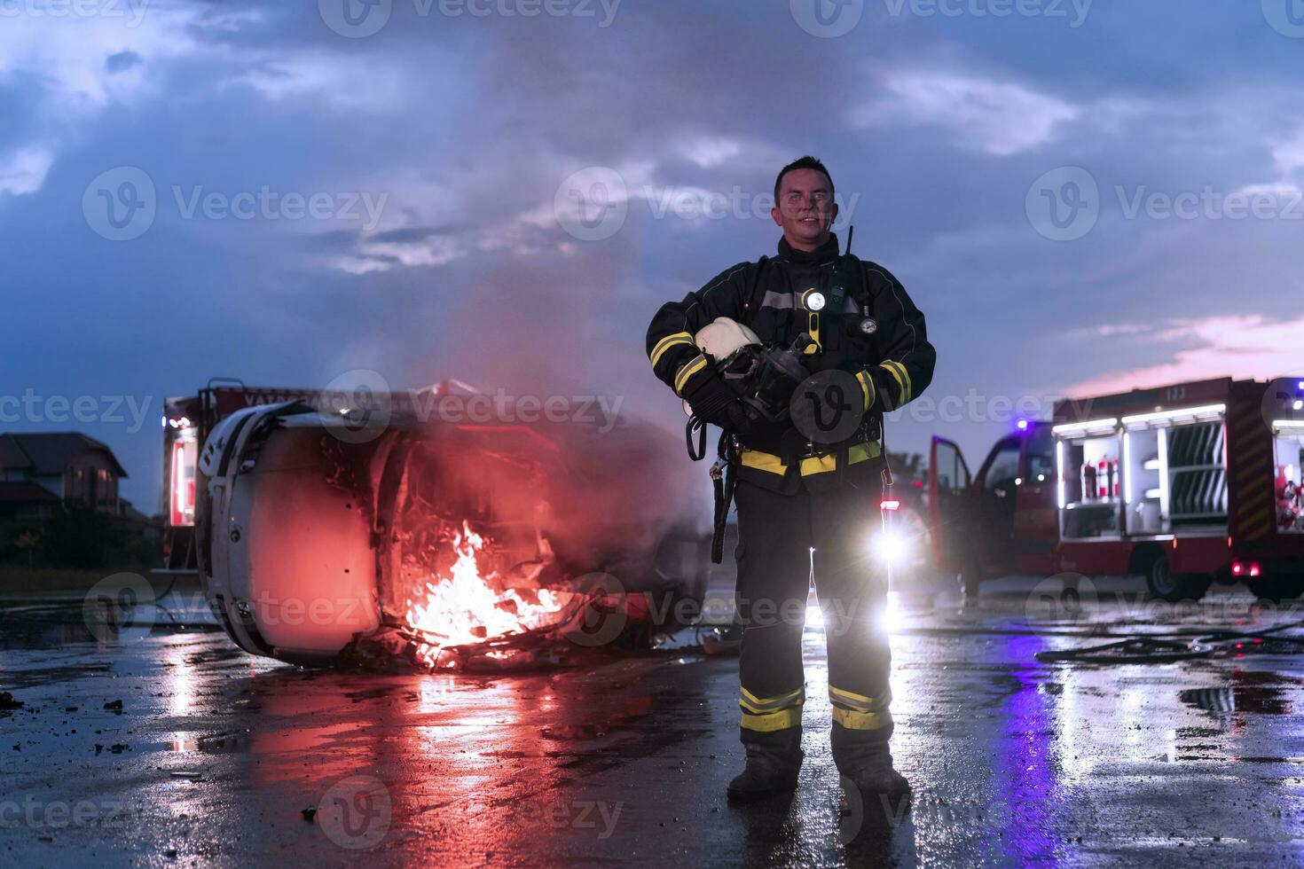 Portrait of a heroic fireman in a protective suit. Firefighter in fire fighting operation. photo