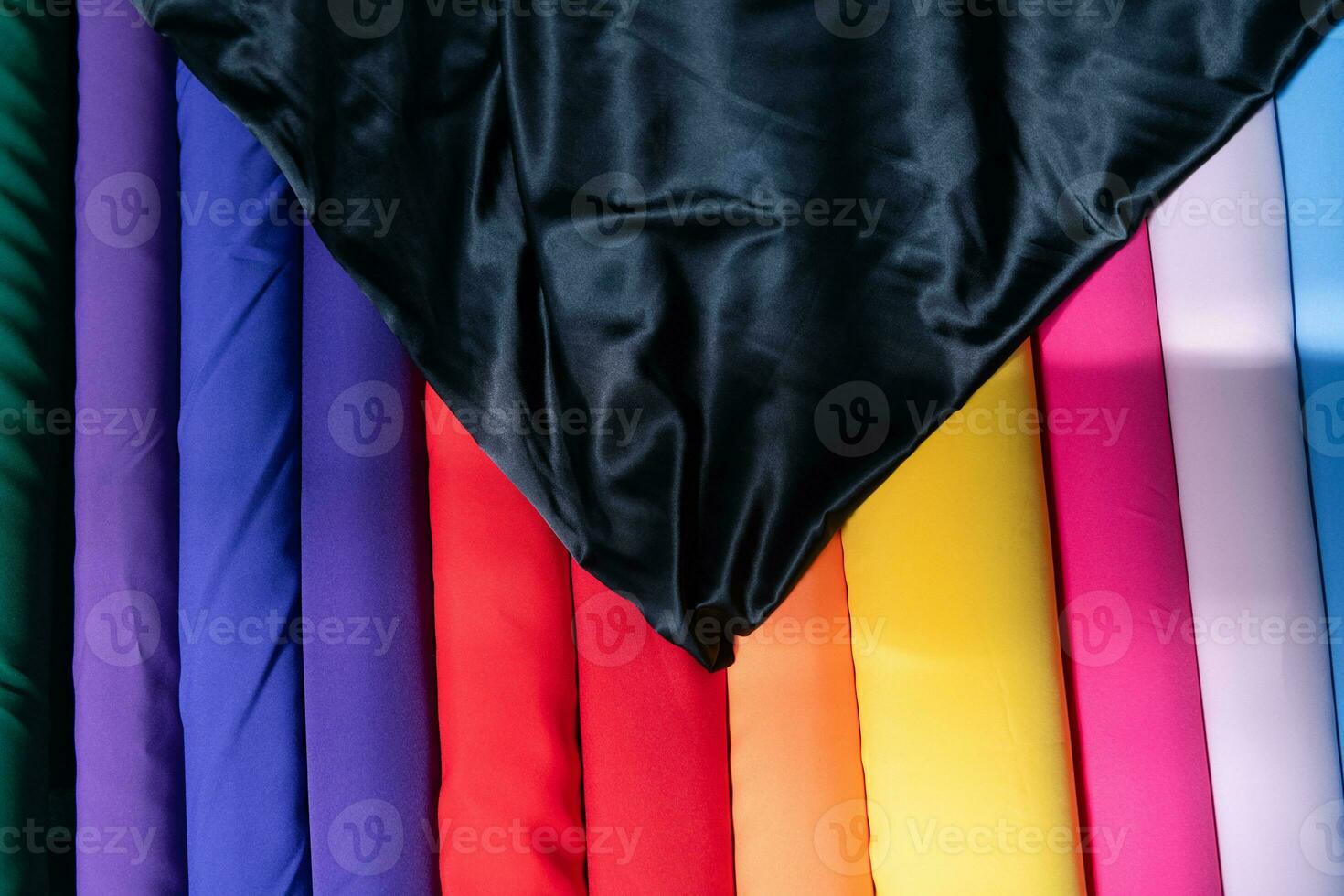 Collection of fashionable fabrics. Samples of different natural fabrics for sewing a fashion collection of clothes. Large selection of fabrics in the store or tailor warehouse. photo