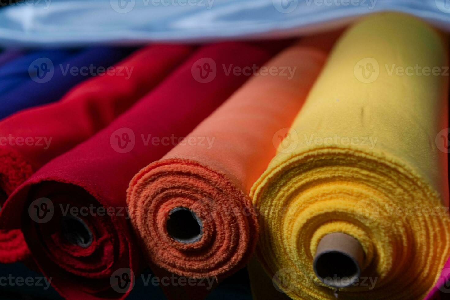 Collection of fashionable fabrics. Samples of different natural fabrics for sewing a fashion collection of clothes. Large selection of fabrics in the store or tailor warehouse. photo