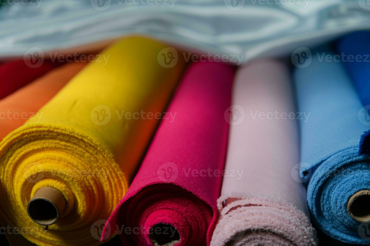Collection of fashionable fabrics. Samples of different natural fabrics for sewing a fashion collection of clothes. Large selection of fabrics in the store or tailor warehouse. photo