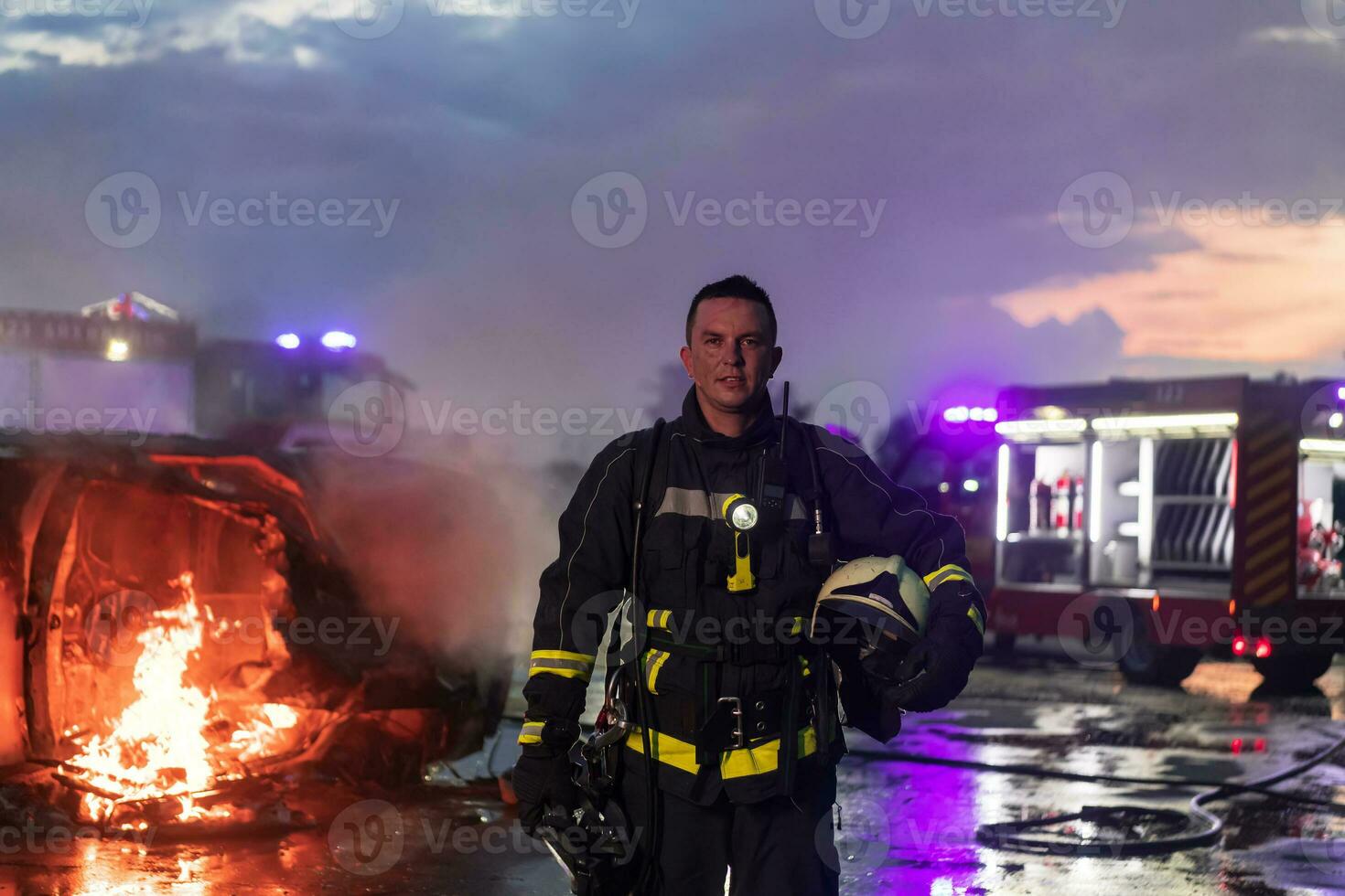 Portrait of a heroic fireman in a protective suit. Firefighter in fire fighting operation. photo