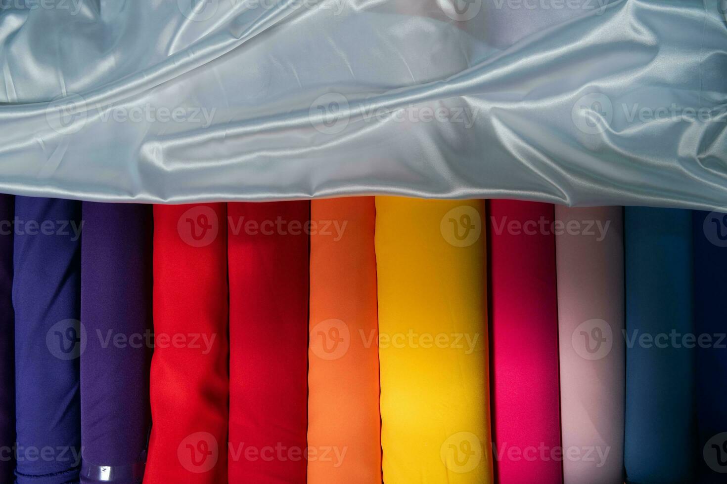 Collection of fashionable fabrics. Samples of different natural fabrics for sewing a fashion collection of clothes. Large selection of fabrics in the store or tailor warehouse. photo