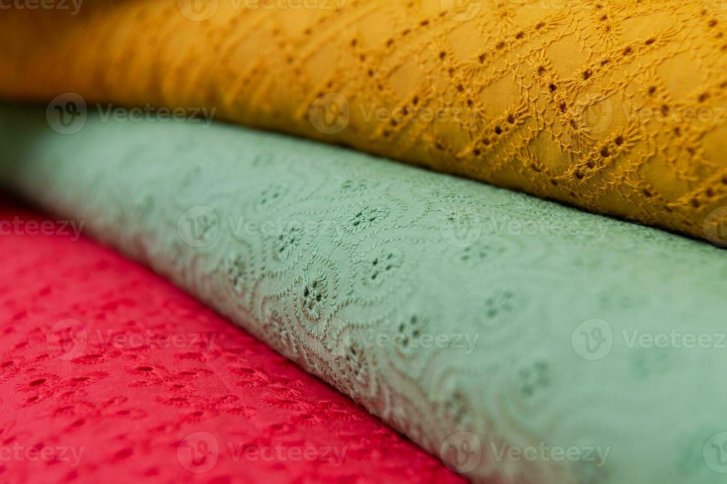 Collection of fashionable fabrics. Samples of different natural fabrics for sewing a fashion collection of clothes. Large selection of fabrics in the store or tailor warehouse. photo