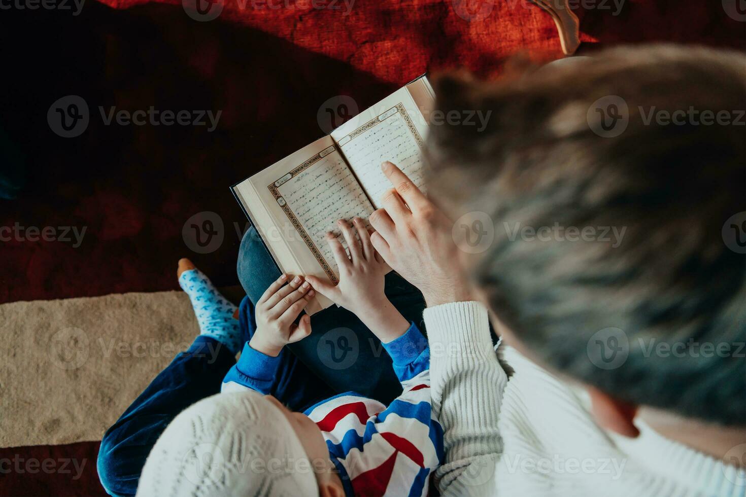 Muslim prayer father and son in mosque praying and reading holly book Quran together islamic education concept photo