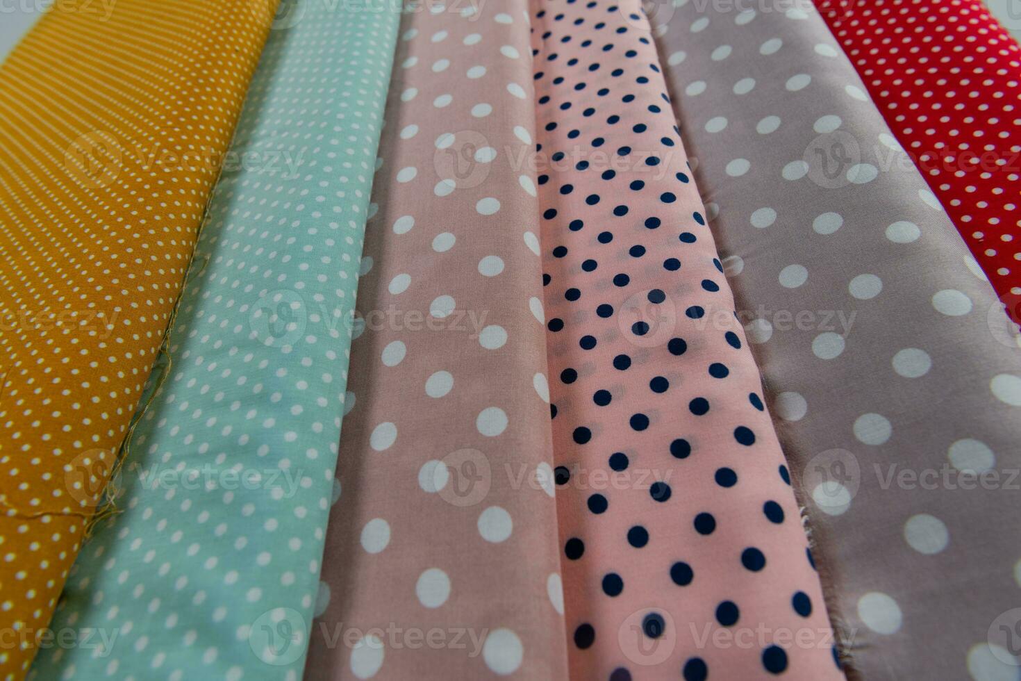 Collection of fashionable fabrics. Samples of different natural fabrics for sewing a fashion collection of clothes. Large selection of fabrics in the store or tailor warehouse. photo