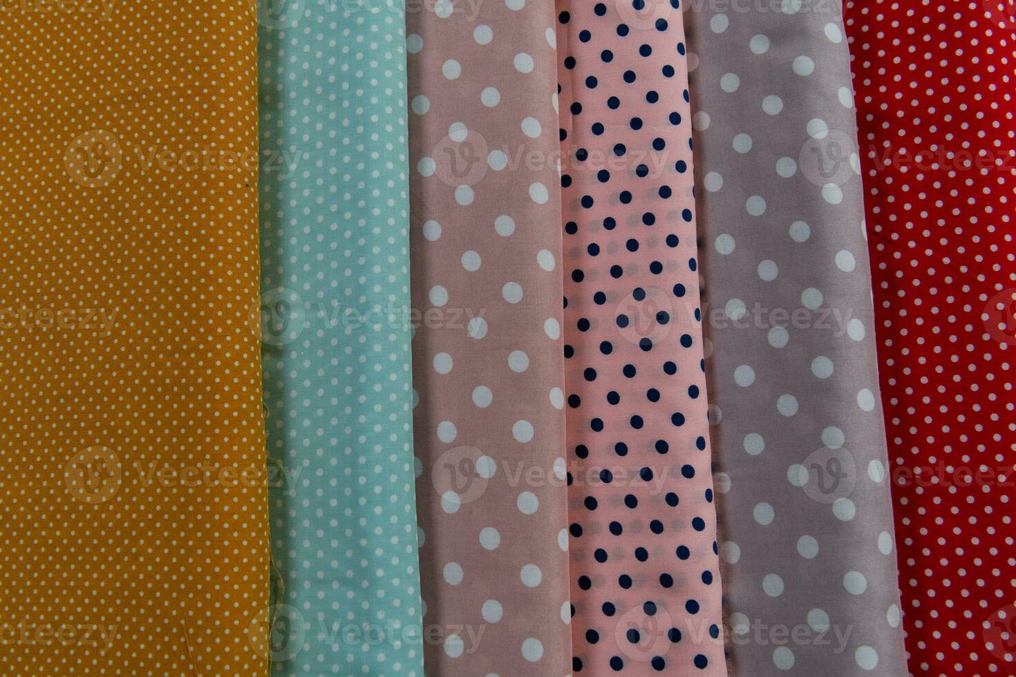 Collection of fashionable fabrics. Samples of different natural fabrics for sewing a fashion collection of clothes. Large selection of fabrics in the store or tailor warehouse. photo