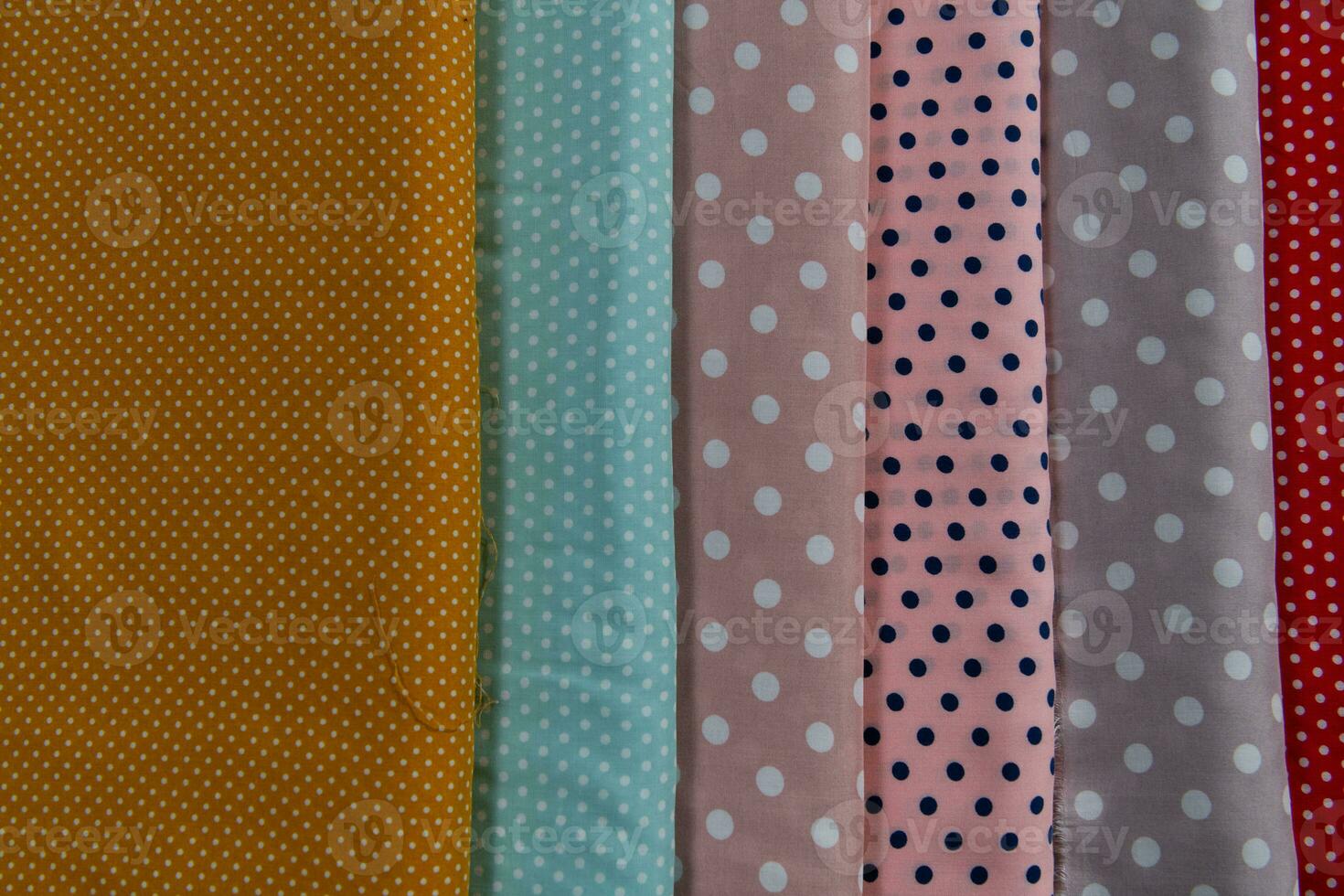 Collection of fashionable fabrics. Samples of different natural fabrics for sewing a fashion collection of clothes. Large selection of fabrics in the store or tailor warehouse. photo