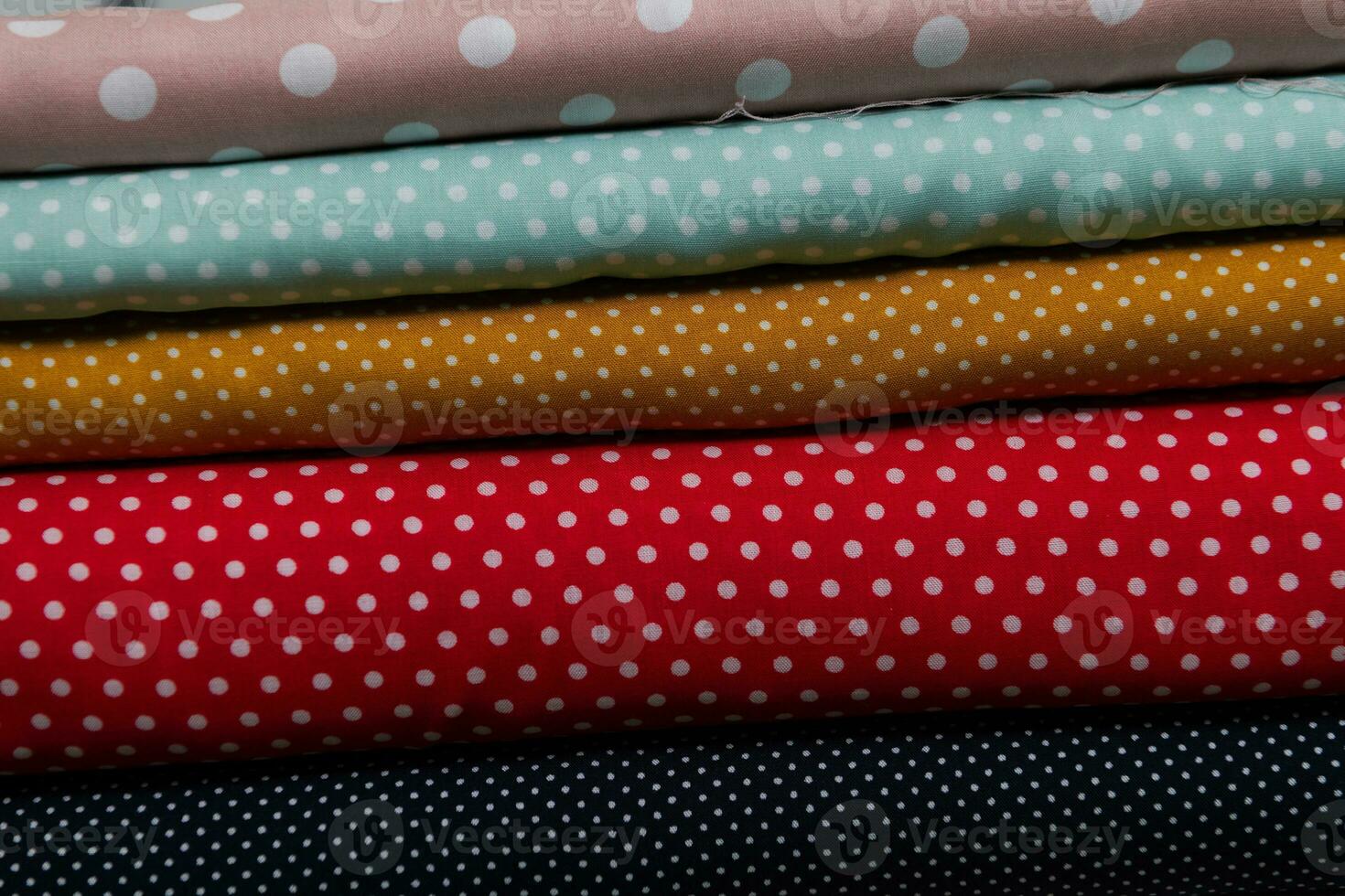 Collection of fashionable fabrics. Samples of different natural fabrics for sewing a fashion collection of clothes. Large selection of fabrics in the store or tailor warehouse. photo